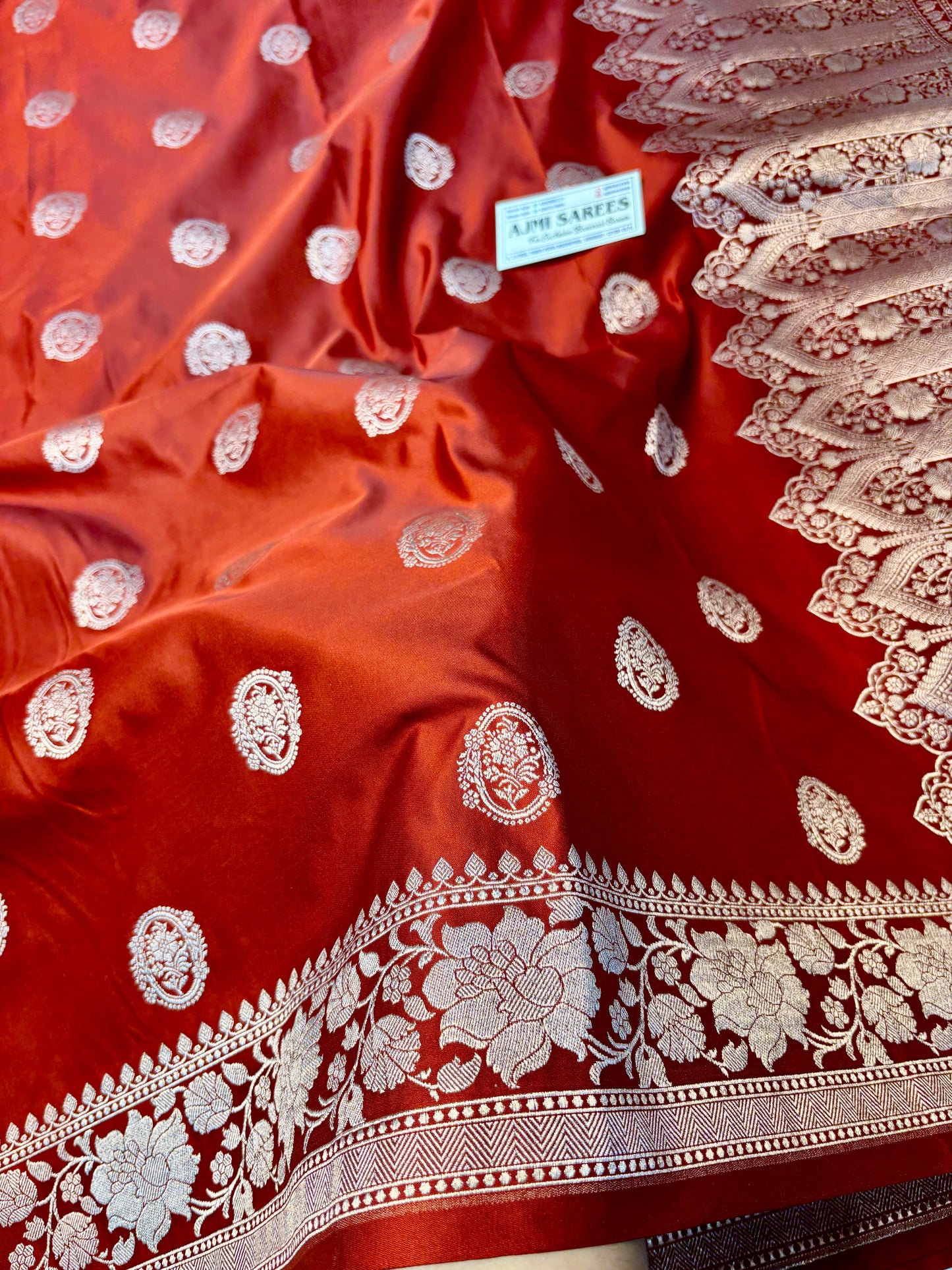 Rust orange Katan silk Banarasi saree with floral border