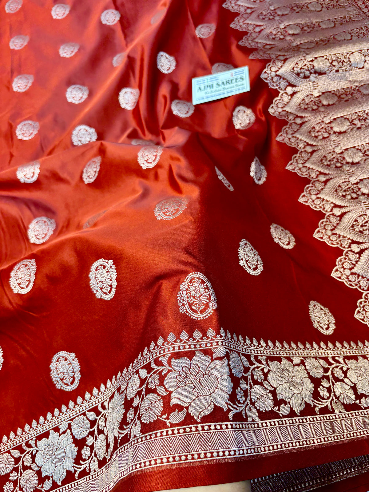 Rust orange Katan silk Banarasi saree with floral border