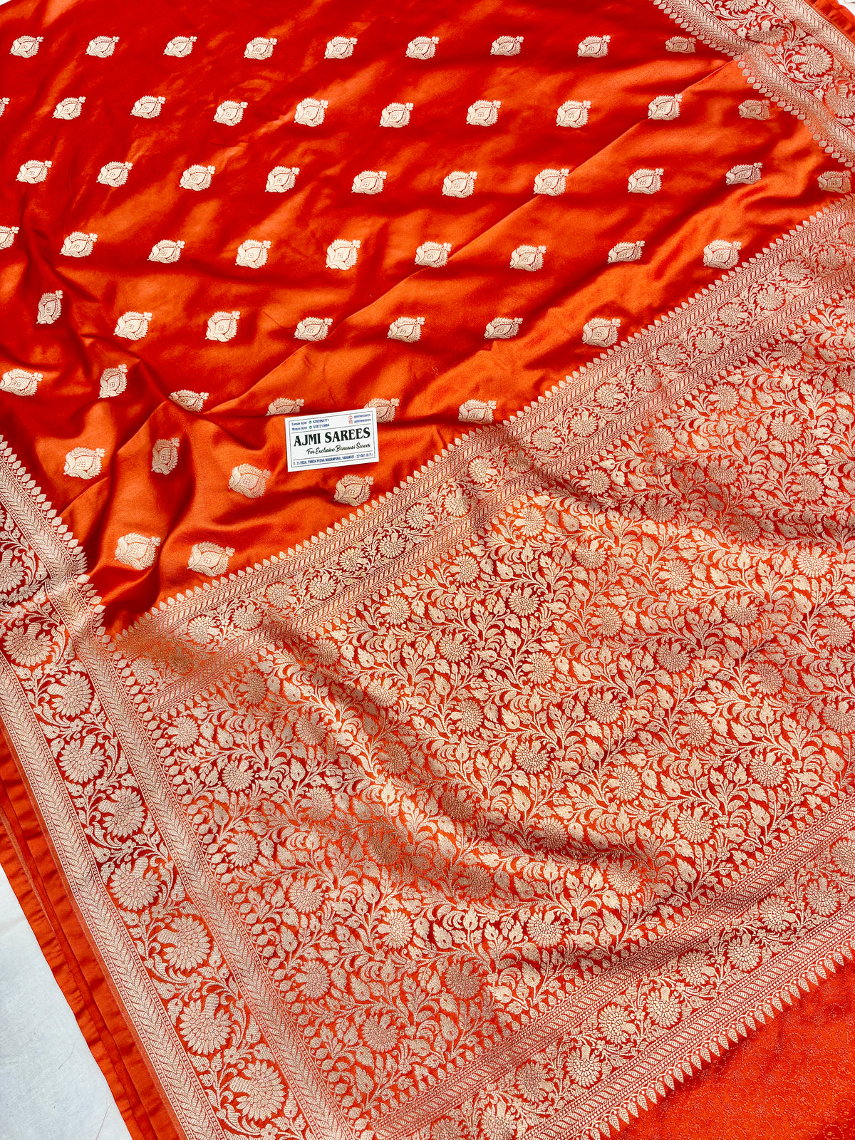 Rust Mashru Katan Banarasi saree with elaborate golden zari border and buta design