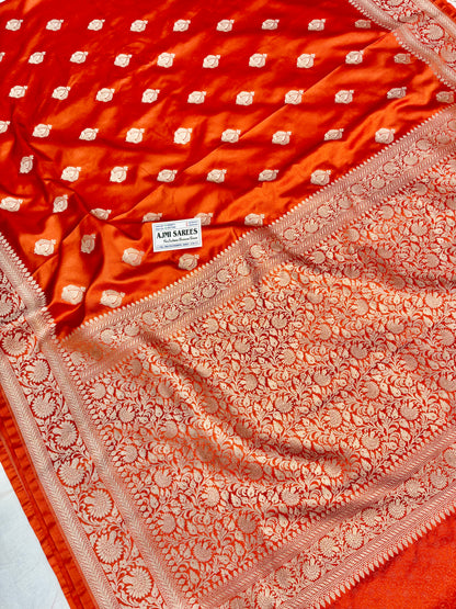 Rust Mashru Katan Banarasi saree with elaborate golden zari border and buta design