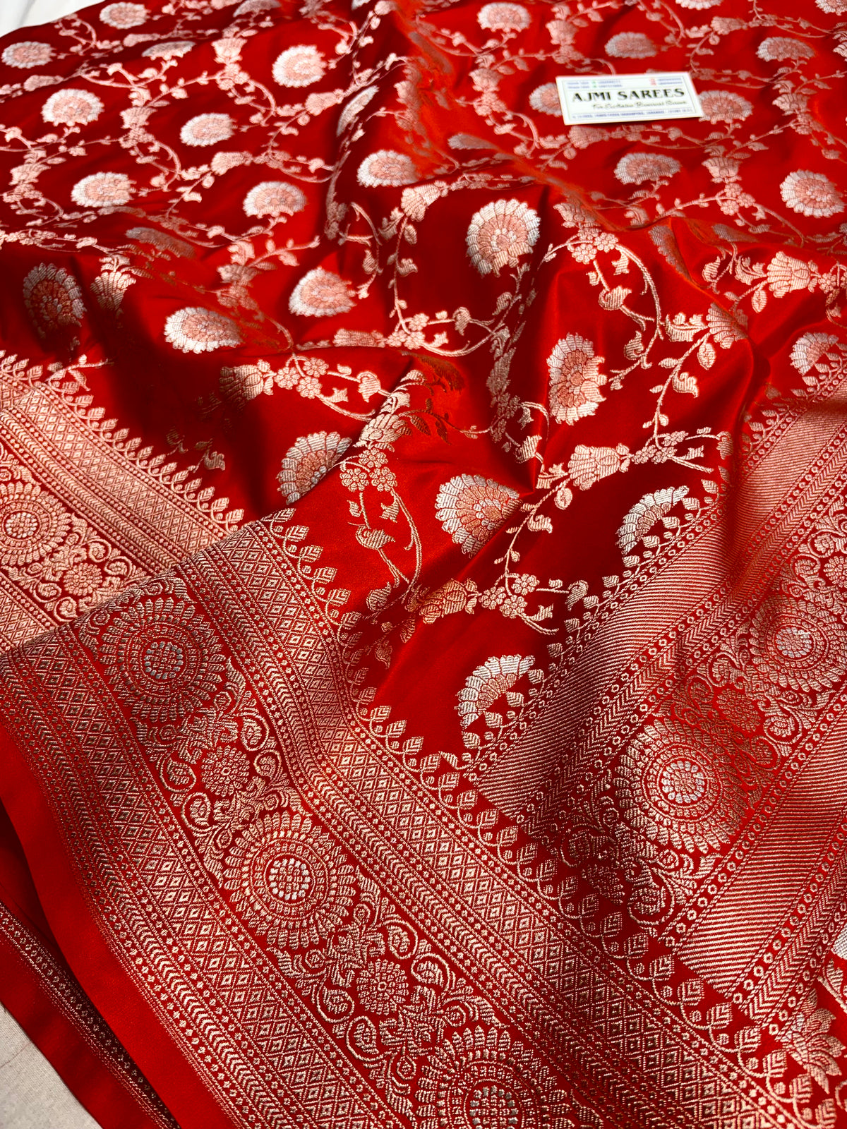 Premium orange Banarasi saree featuring gold zari base with Rupa Meenakari zari work