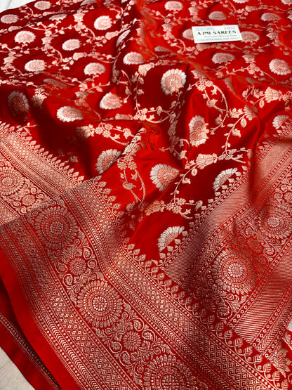 Premium orange Banarasi saree featuring gold zari base with Rupa Meenakari zari work