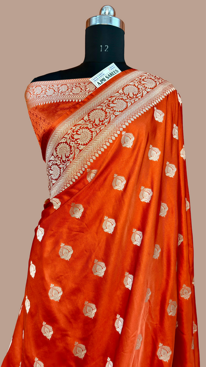 Luxury rust Katan silk Banarasi saree featuring golden zari woven buta motifs
