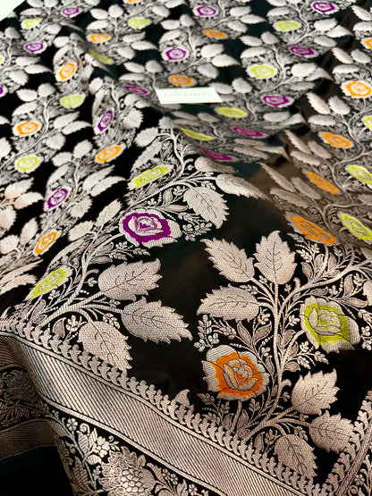 Black Mashru Katan silk Banarasi saree featuring intricate silver zari floral vines and colourful Meenakari flowers