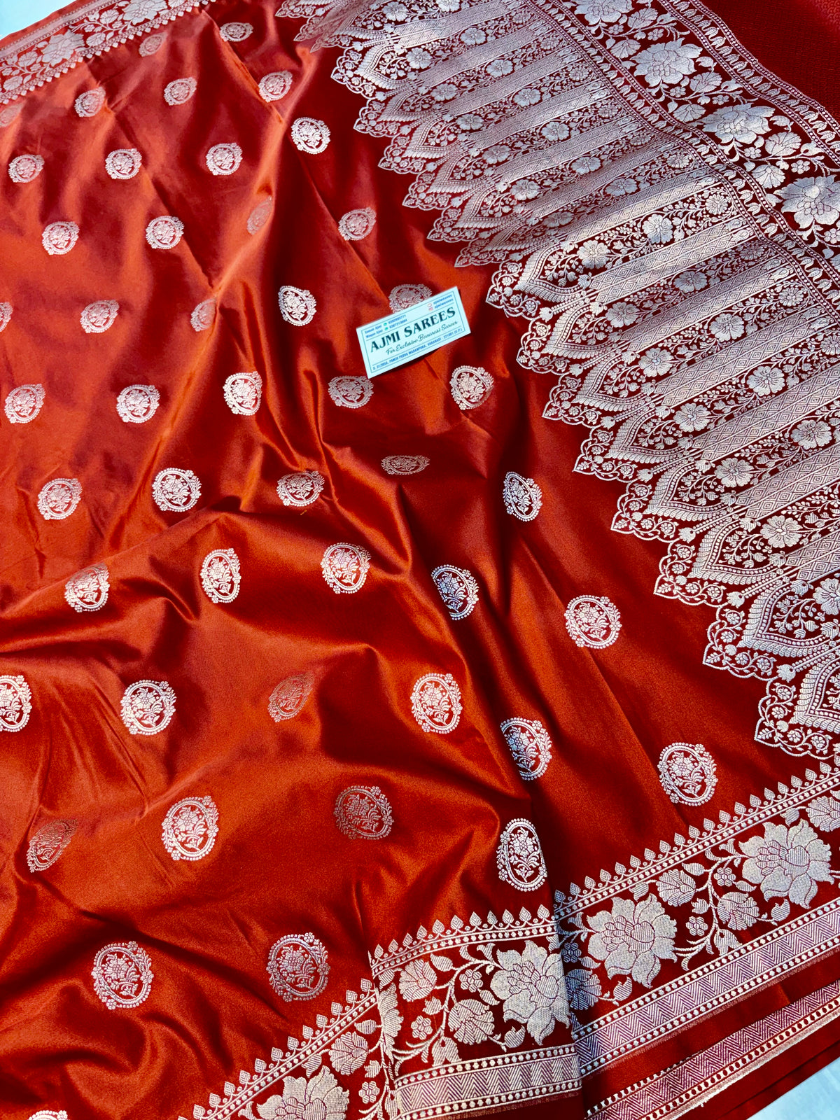 Traditional rust orange Banarasi saree with zari buta motifs