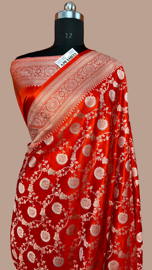 Luxury orange Banarasi silk saree with gold zari border and Rupa silver Meenakari detailing
