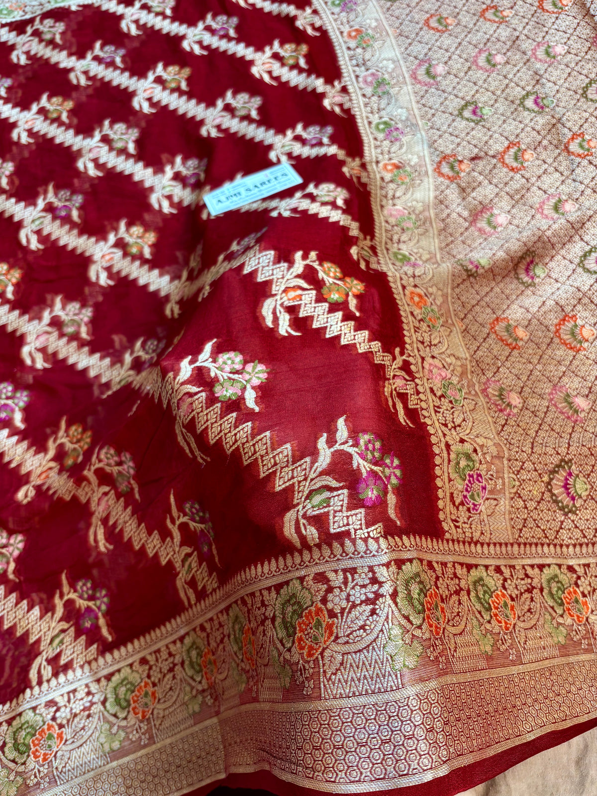 Maroon Tilfi Banarasi saree featuring intricate water zari work