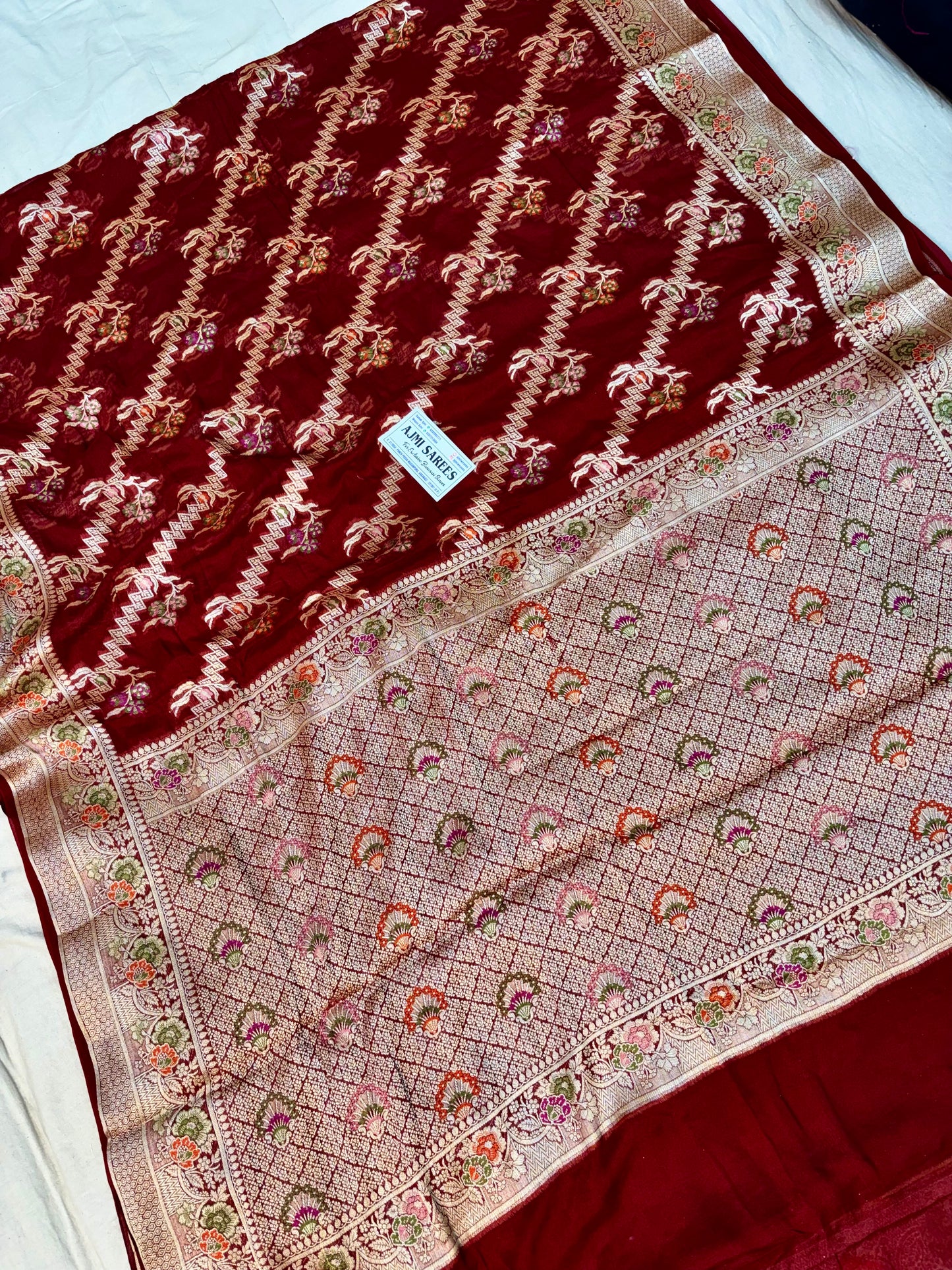 Maroon Banarasi saree with traditional floral Tilfi weaving