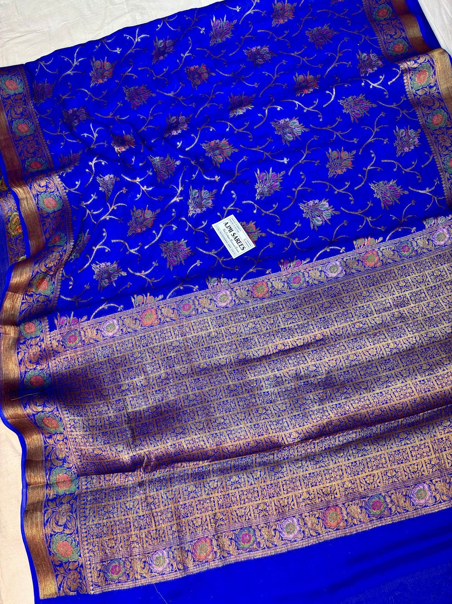 Royal blue Banarasi saree with antique copper zari and floral motifs