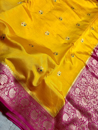 Yellow mango silk saree with floral zari border close up