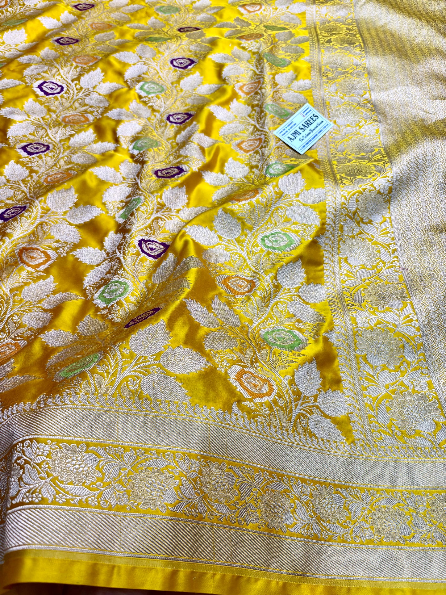 bright yellow saree with multicolor meenakari motifs