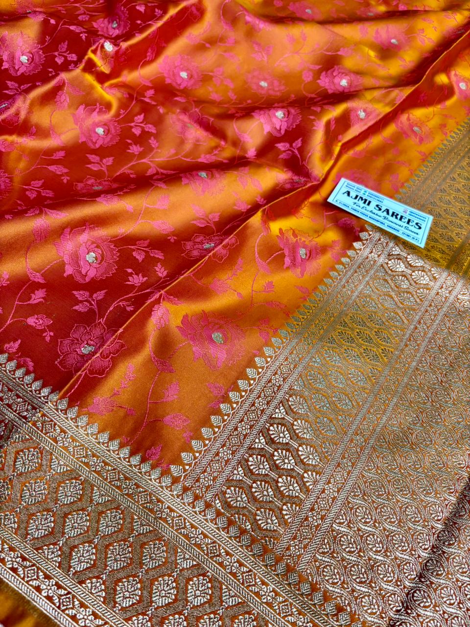 vibrant dual tone orange pink banarasi saree with intricate border and floral motifs