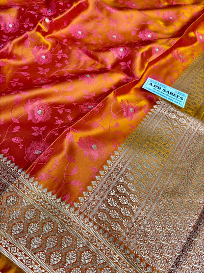 vibrant dual tone orange pink banarasi saree with intricate border and floral motifs